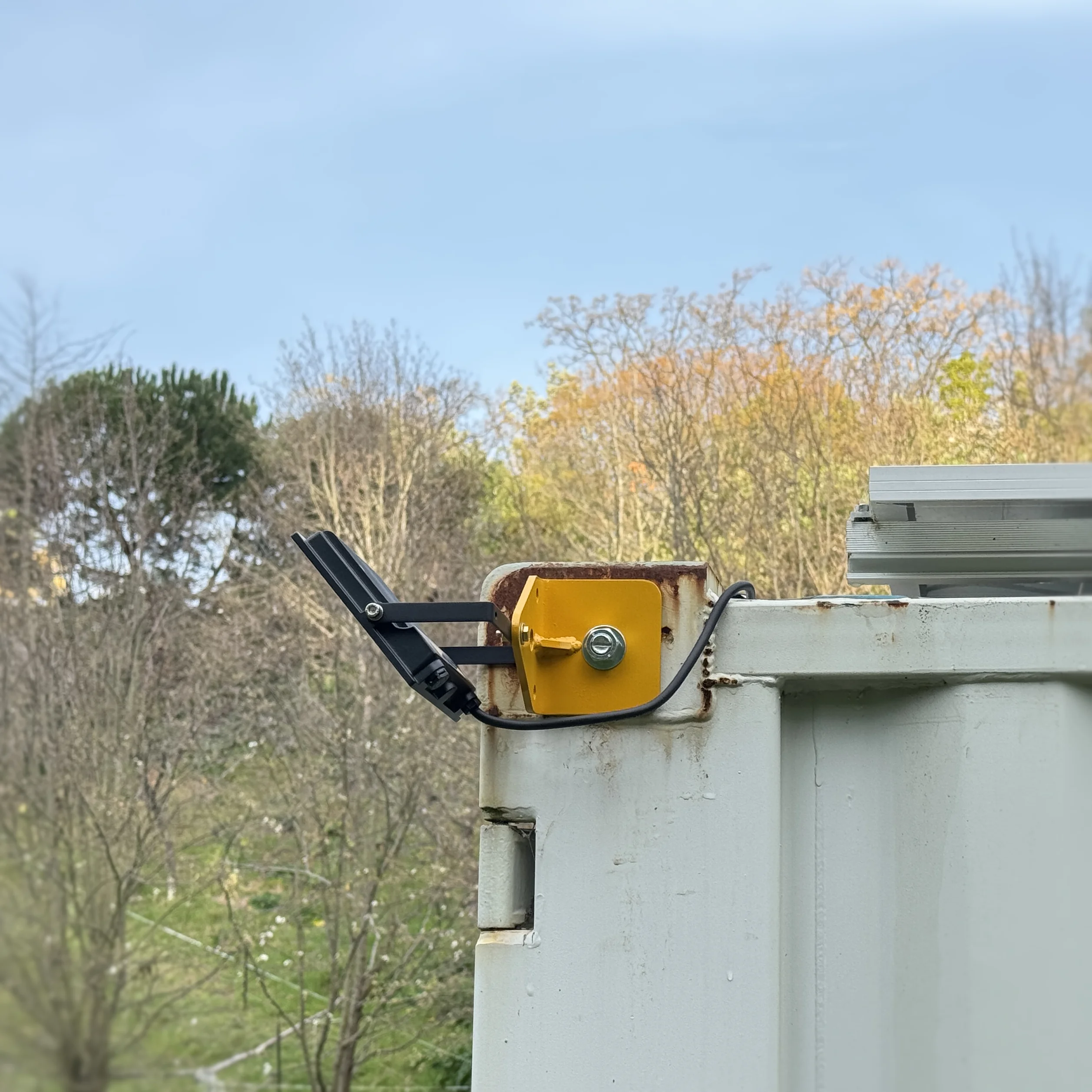 CornerLink mounting a floodlight on a container corner casting